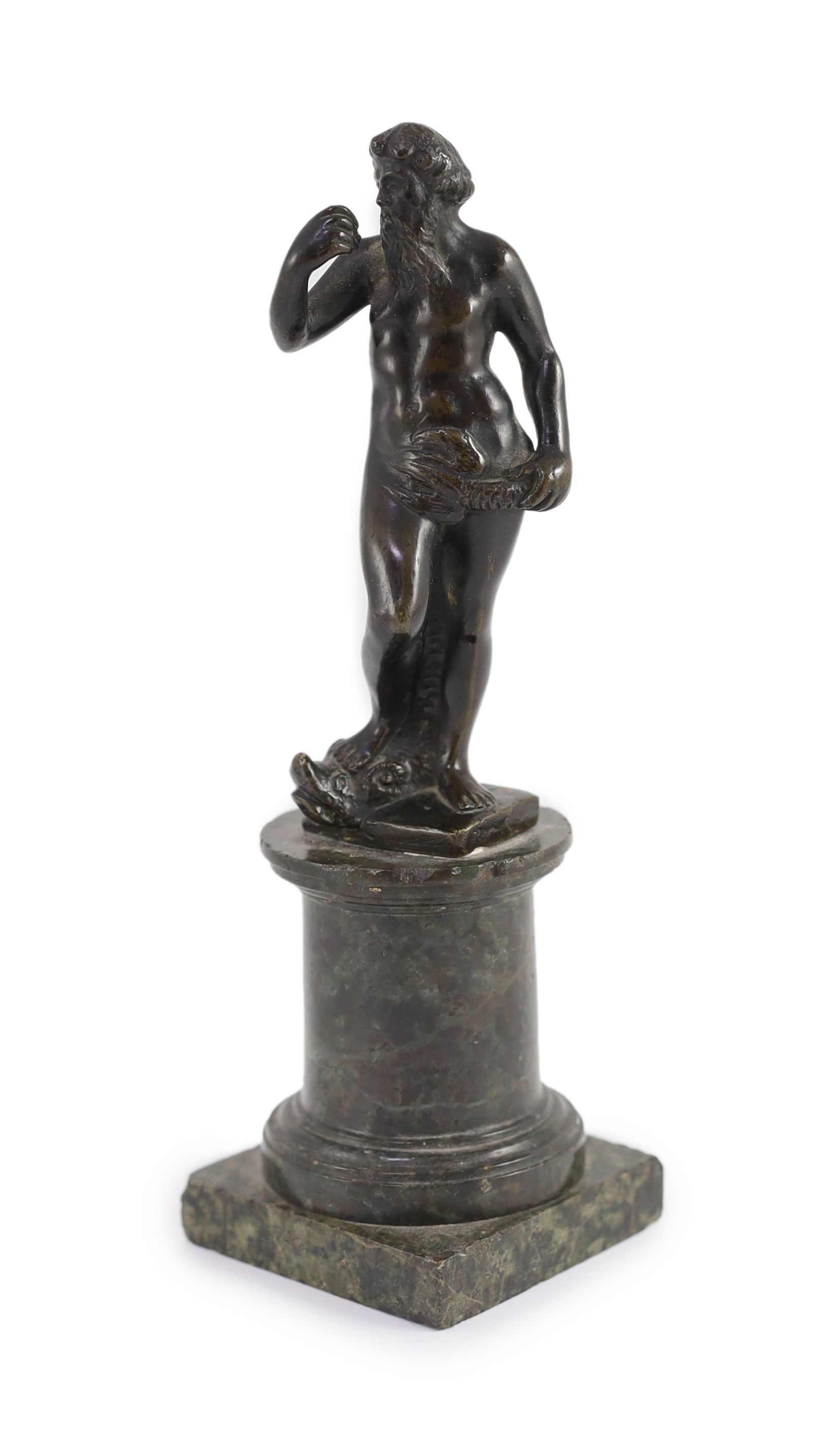 A small Roman bronze figure of Neptune standing with his foot upon a dolphin, overall height 21cm